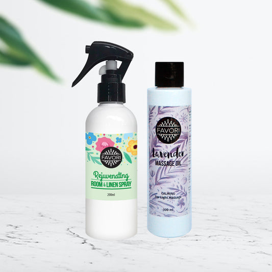 Two bottles of FAVORI Scents' home fragrance products on a surface, one labeled "rejuvenating room & linen spray" and the other "lavender massage oil".