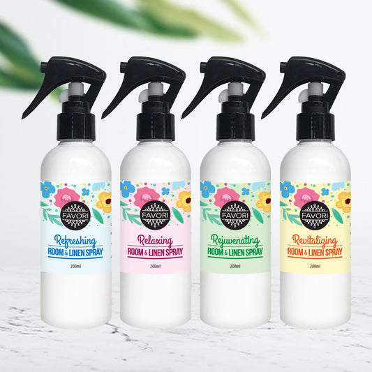 Four bottles of FAVORI Scents Air Spray (200ml) with different scents, including essential oils, displayed in a row.
