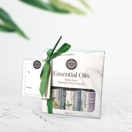 A set of three FAVORI Scents 10ml Pure Essential Oils - Starter Set of 3 bottles in packaging with a green and gold ribbon and a gift tag.