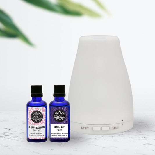 Aroma diffuser with two bottles of FAVORI essential oils, cherry blossoms, and sunset bay scents.