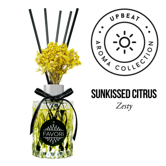 A Sunkissed Citrus Premium Reed Diffuser from the upbeat aroma collection by FAVORI Scents, decorated with yellow flowers and a black ribbon, contains oil for a lasting fragrance.