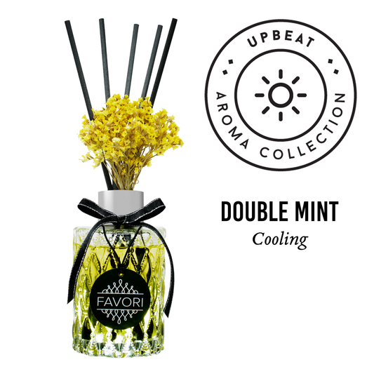 Reed diffuser with yellow flowers, labeled "FAVORI Scents Double Mint Premium Reed Diffuser," shown with a sun-inspired brand logo and fiber reed sticks.
