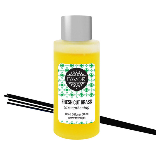 A bottle of FAVORI Scents Fresh Cut Grass Regular Reed Diffuser (RRD) with black sticks.