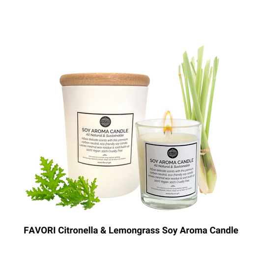 A FAVORI Scents Citronella & Lemongrass Soy Aroma Candle with fresh lemongrass stems, green leaves, and favori oil on a white background.
