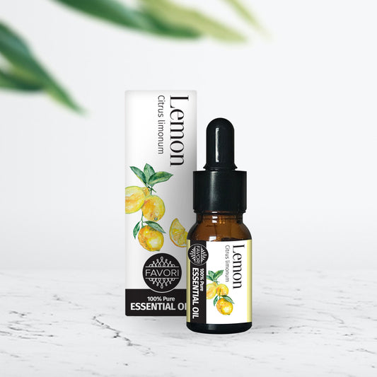 A bottle of FAVORI Scents Essential Oil-Lemon (10ml) for Aromatherapy with its packaging box on a white surface against a marble background.