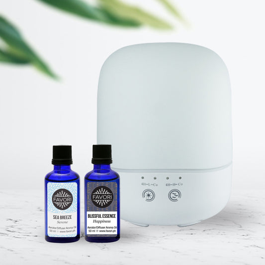 An essential oil diffuser with two bottles of FAVORI Scents aromatic oils.
