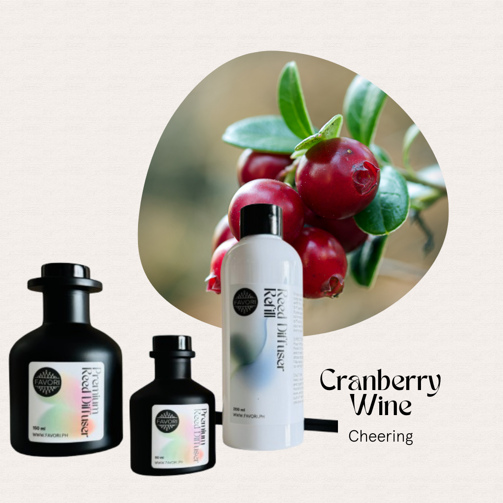 Cranberries above three FAVORI Scents Cranberry Wine Trio Premium Reed Diffuser bottles, Cheering scent.