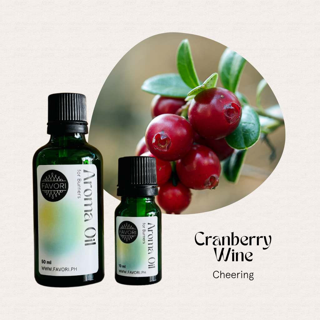 Two bottles of FAVORI Scents Burner Aroma Oils, Cranberry Wine Cheering, beside fresh cranberries.