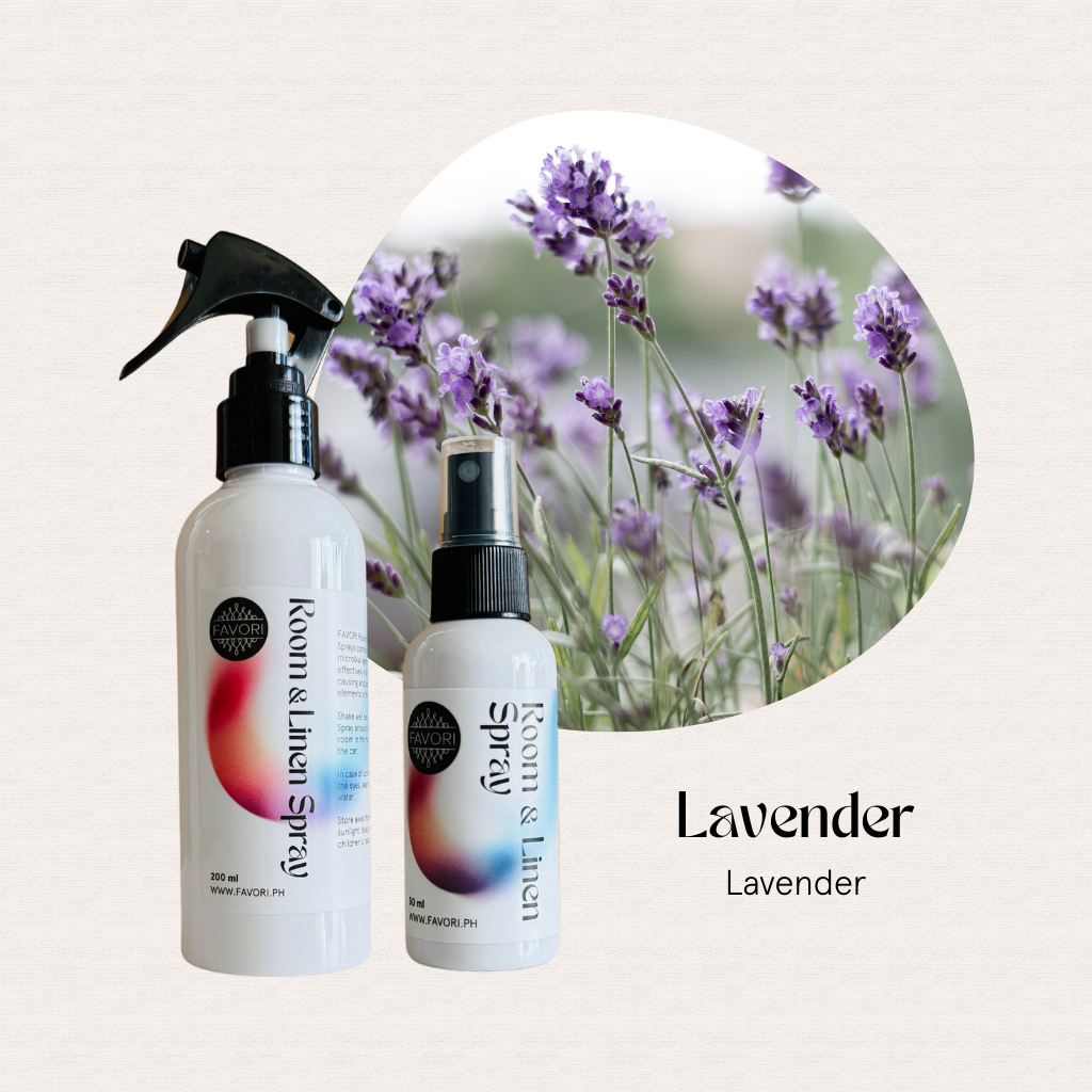 Two FAVORI Scents Regular Room & Linen Air Spray bottles with blooming lavender flowers in the background.