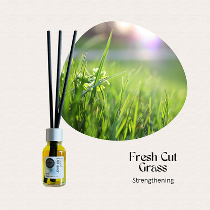 A FAVORI Scents Mini Reed Diffuser in Fresh Cut Grass, with fiber sticks for a strengthening aroma.