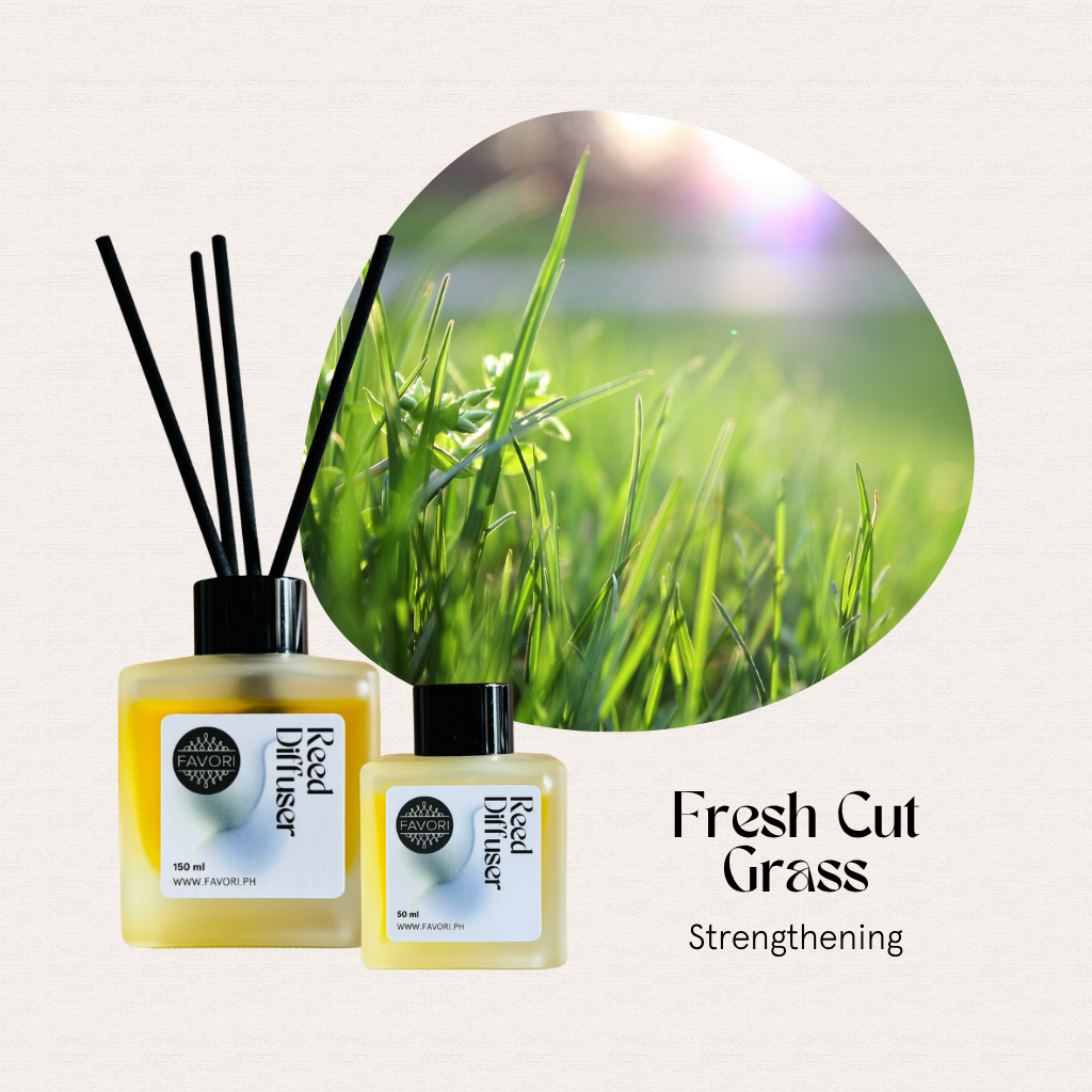 Two FAVORI Scents Fresh Cut Grass RRDs with yellow liquid beside sunlit grass; text: Fresh Cut Grass scent.