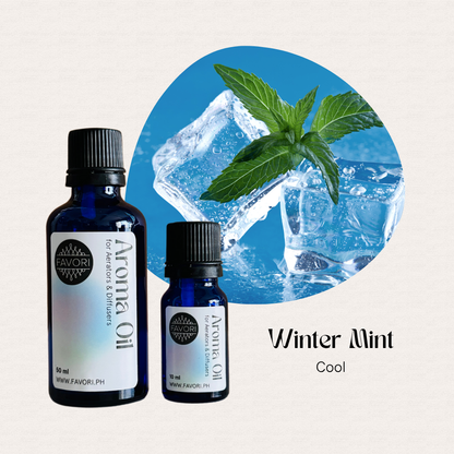 Two blue bottles of FAVORI Scents AD Aroma Oils, Winter Mint Cool scent with ice cubes and mint.