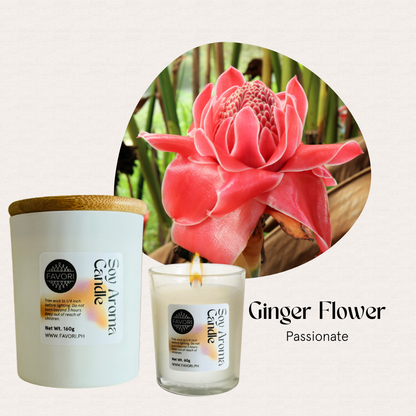 A pink ginger flower beside two FAVORI Scents All Occasion candles: Ginger Flower and Passionate.