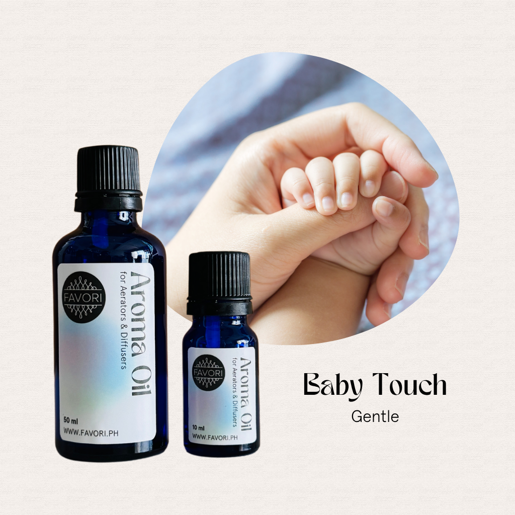 Two FAVORI Scents Aerator/Diffuser Aroma Oils beside an adult hand gently holding a babys hand.
