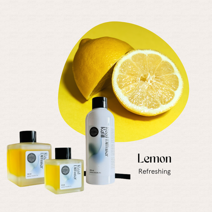 A halved lemon and three FAVORI Scents Lemon Trio Reed Diffuser (TRD) bottles on a yellow background.