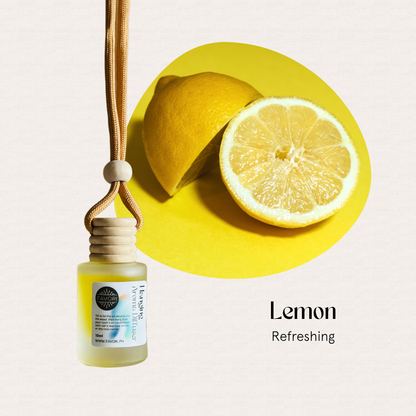 A sliced lemon beside a FAVORI Scents Hanging Aroma Diffuser (HAD) on a vibrant yellow background.