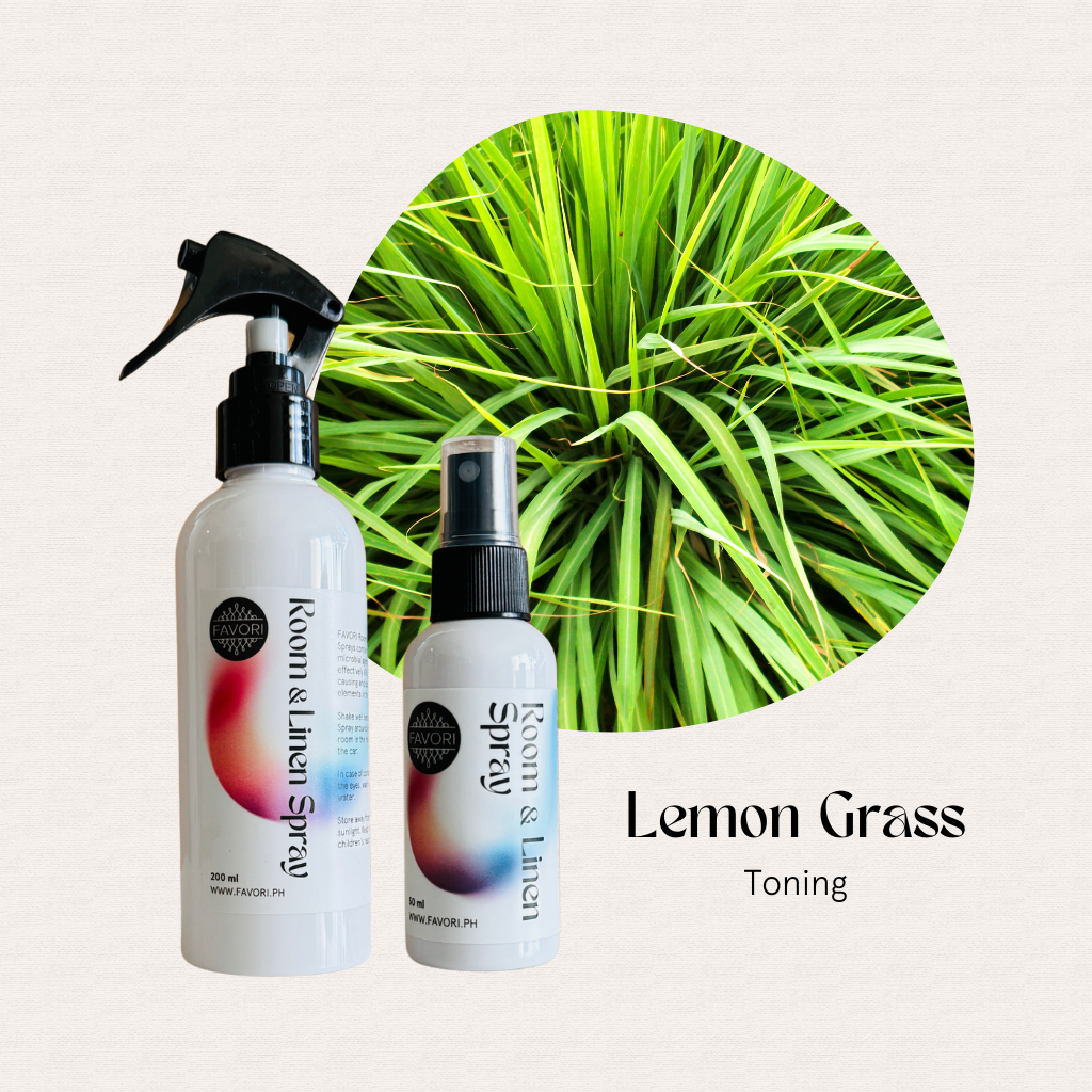 Two FAVORI Scents Regular Room & Linen Air Sprays are placed in front of a round lemongrass plant.