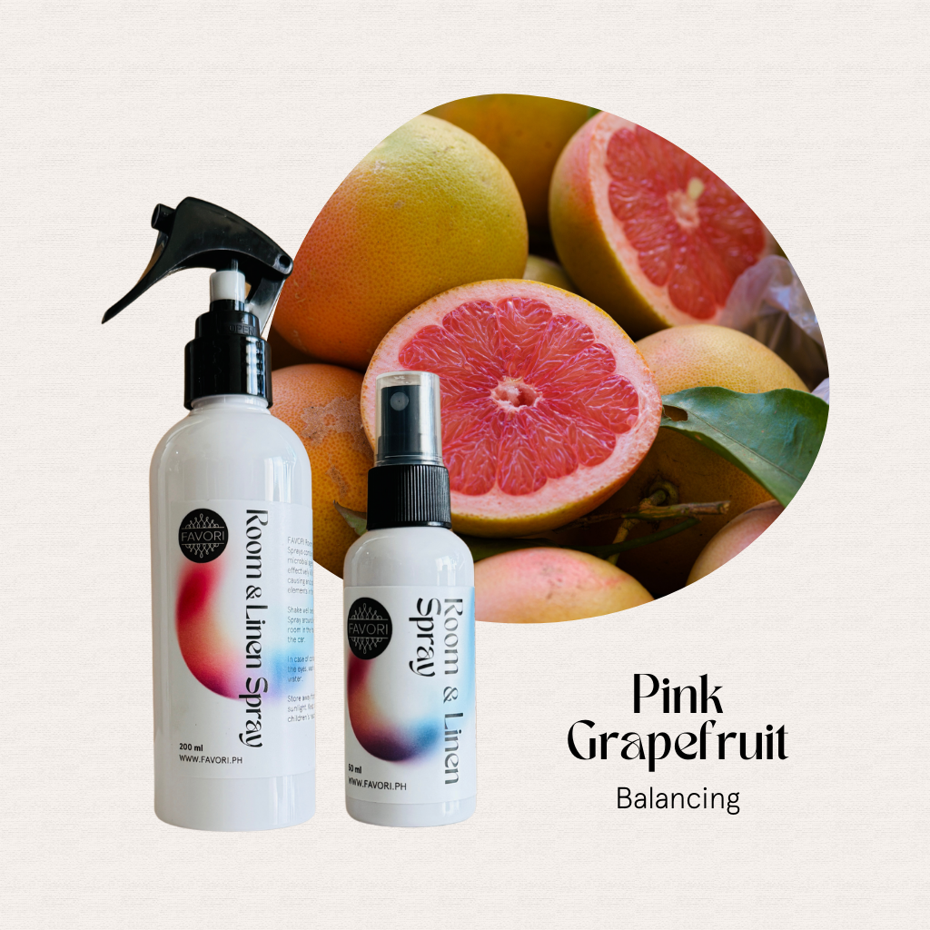 Two FAVORI Scents Regular Room & Linen Air Sprays with fresh pink grapefruit slices in the background.