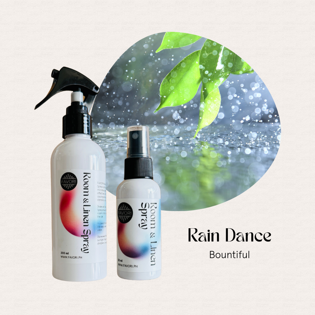 Two FAVORI Scents Regular Room & Linen Air Sprays in front of a rain-leaf background, labeled Rain Dance Bountiful.