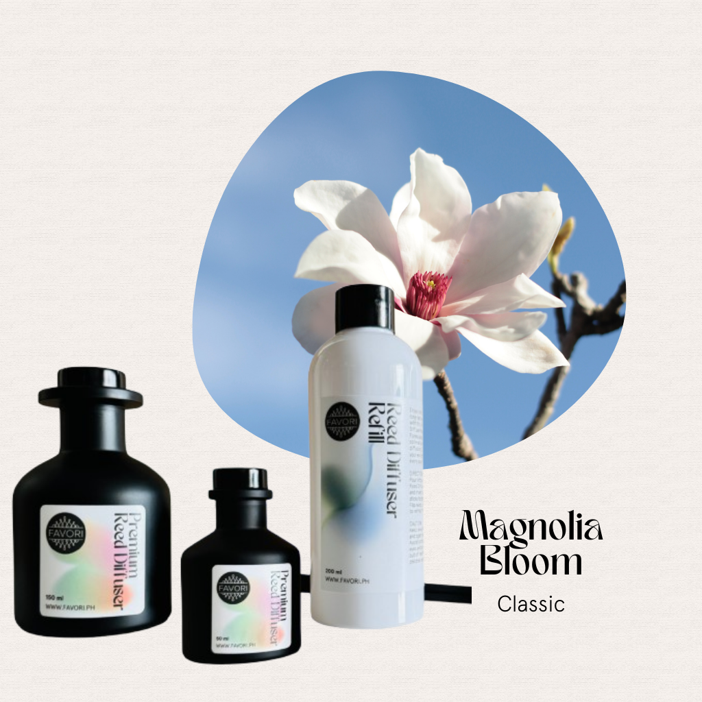 Three FAVORI Scents Magnolia Bloom Trio Premium Reed Diffusers sit before a blooming magnolia flower.