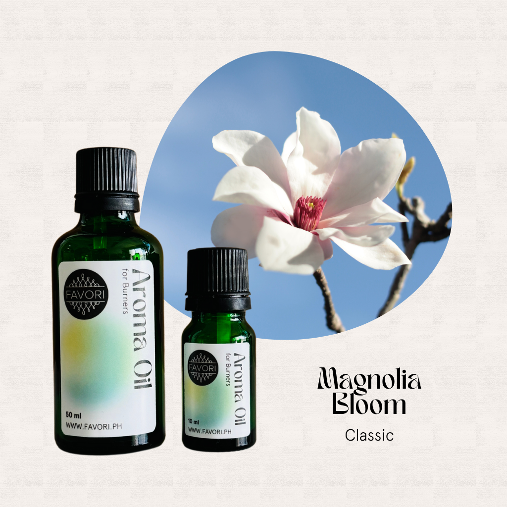 Two green FAVORI Scents Burner Aroma Oils with blooming magnolia, set against a blue sky background.