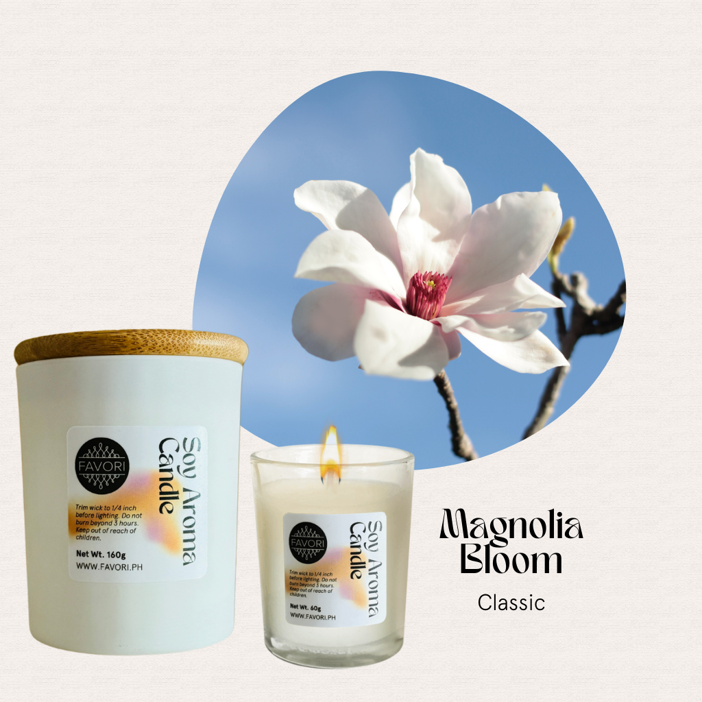 A lit FAVORI Scents All Occasion soy candle and jar with wooden lid, magnolia flower in the background.
