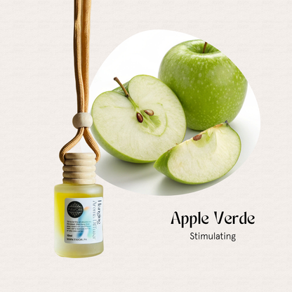 Small bottle on cord near green apples; FAVORI Scents HAD in Apple Verde is a stimulating portable diffuser.