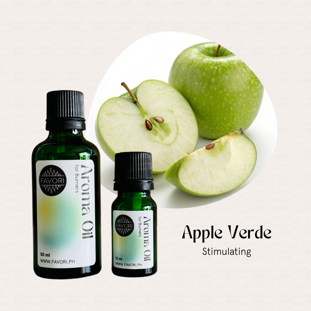 Two bottles of FAVORI Scents Burner Aroma Oils in Apple Verde Stimulating and sliced green apples.