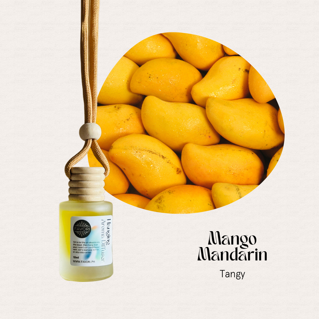 FAVORI Scents Mango Mandarin Hanging Aroma Diffuser (HAD) with cord, beside ripe mangoes. Tangy scent.