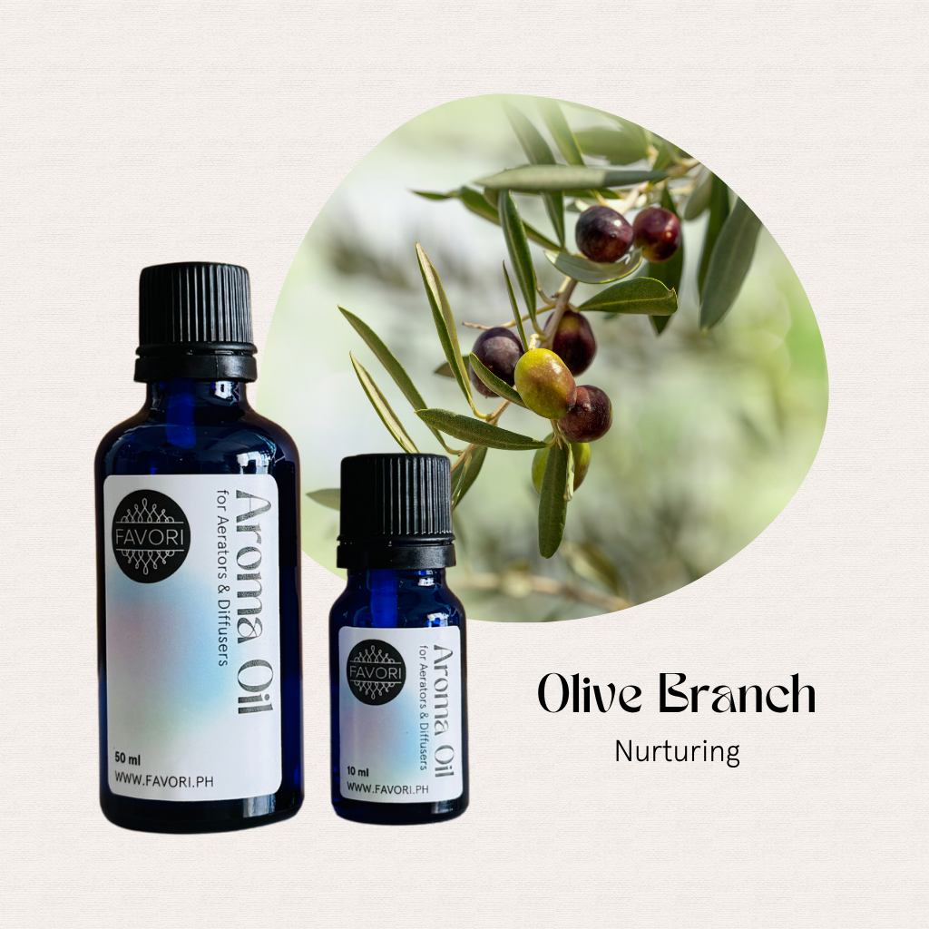 Two blue bottles of FAVORI Scents Aerator/Diffuser Aroma Oils with olives and an olive branch in the background.