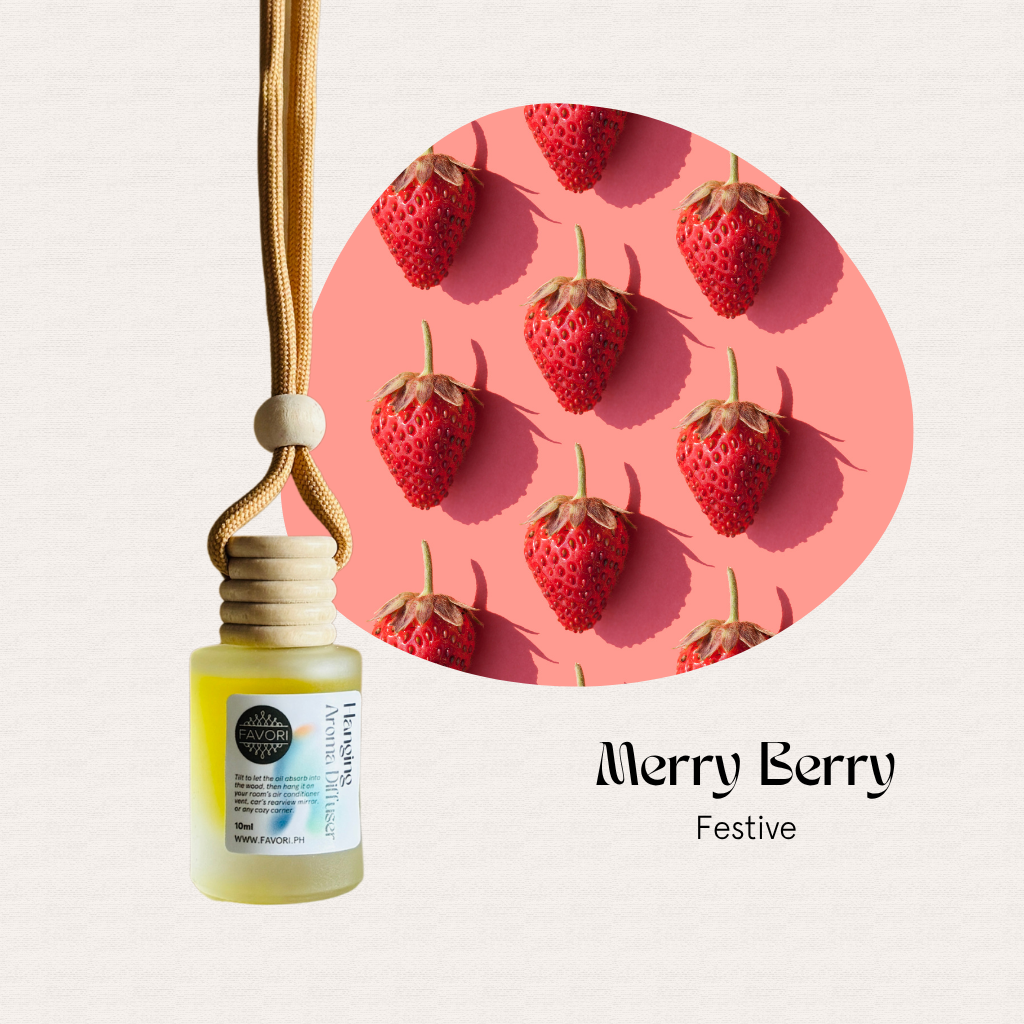 A FAVORI Scents Hanging Aroma Diffuser sits by nine strawberries on pink. Text: Merry Berry Festive.