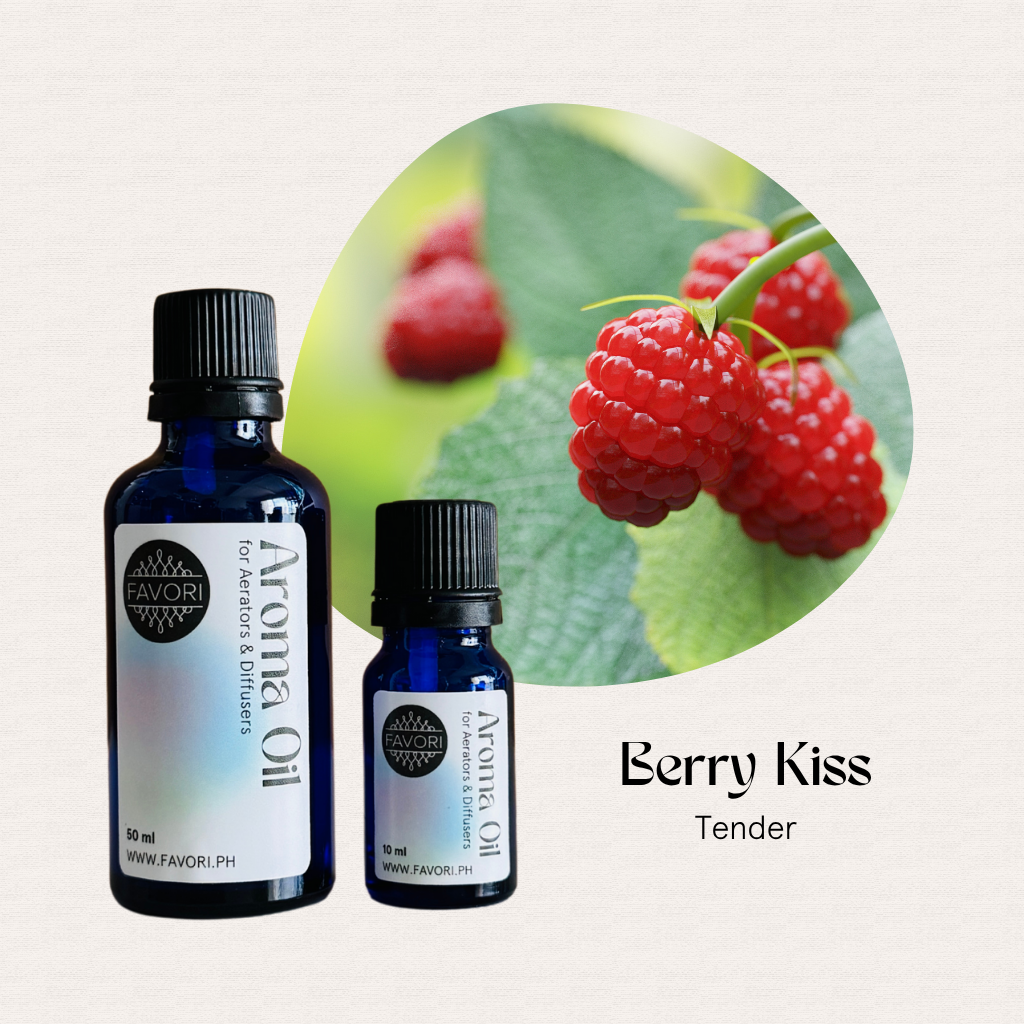 Two blue bottles of FAVORI Scents Aerator/Diffuser Aroma Oils beside ripe raspberries on a leaf.