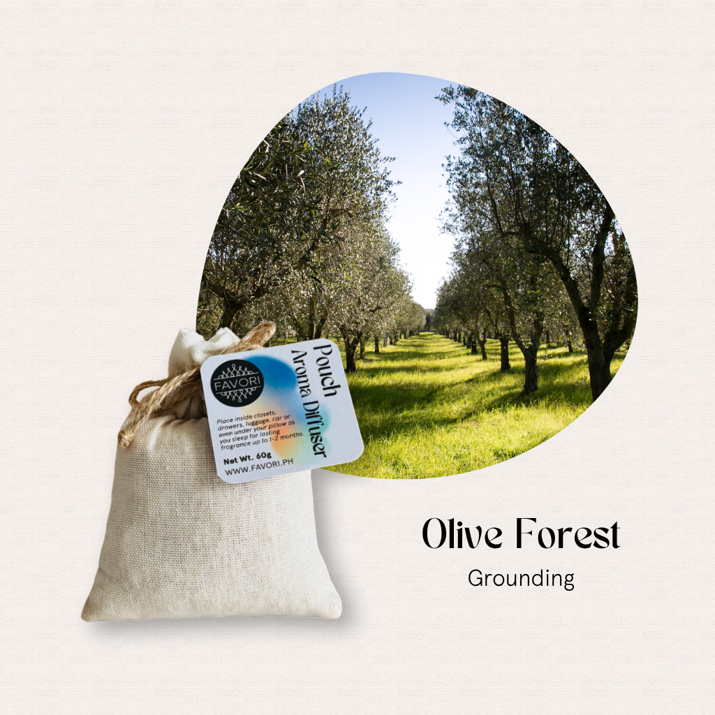 A small PAD by FAVORI Scents in front of an olive grove, labeled Olive Forest Grounding diffuser oil.