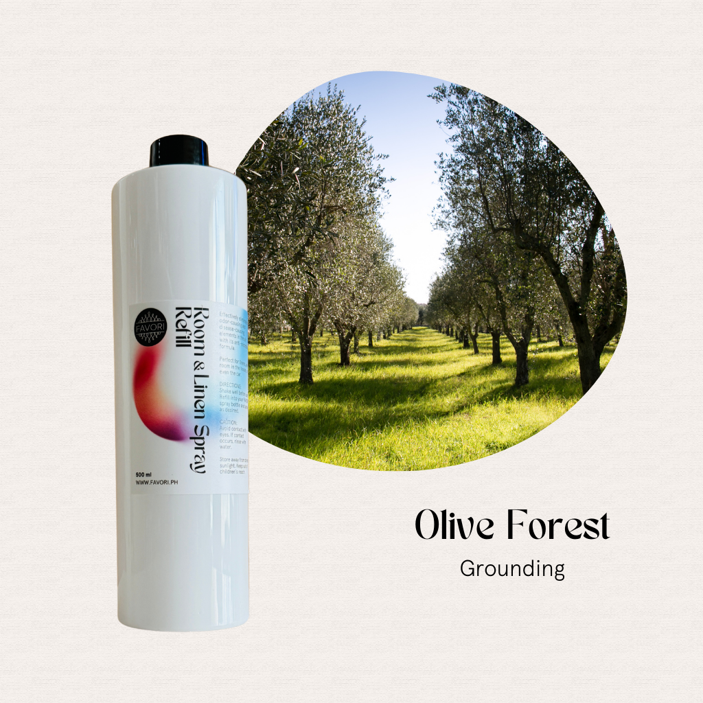 A white FAVORI Scents 500ml air spray labeled Olive Forest Grounding sits by a sunlit olive grove.