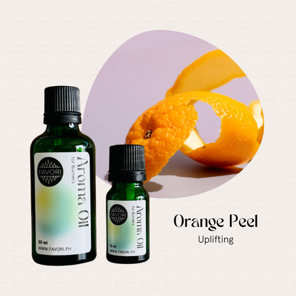 Two FAVORI Scents Burner Aroma Oils and an orange peel curl with text: Orange Peel, Uplifting.