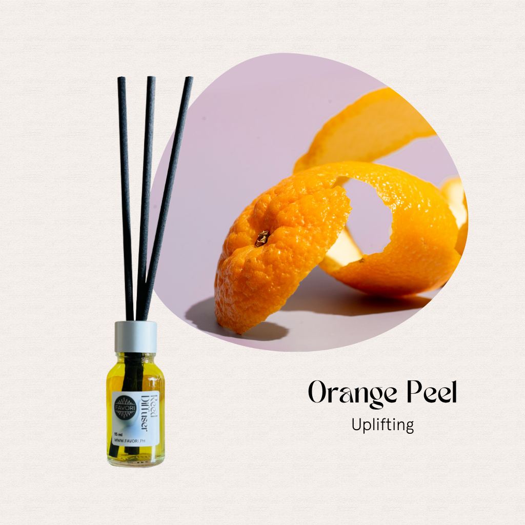 FAVORI Scents Mini Reed Diffusers with yellow oil and fiber sticks beside a curled orange peel.