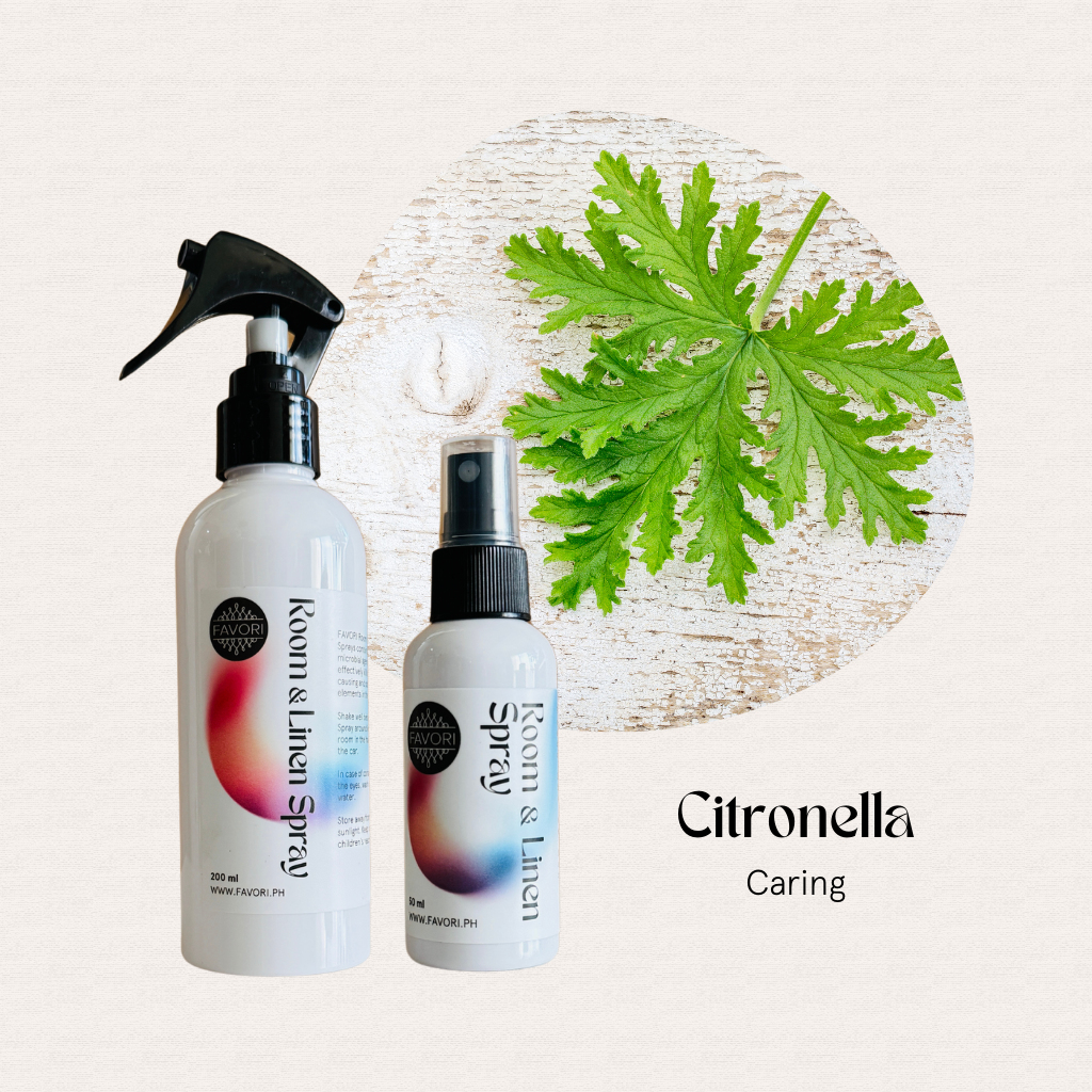 Two FAVORI Scents Regular Room & Linen Air Sprays, green leaf, Citronella Caring text on white wood.