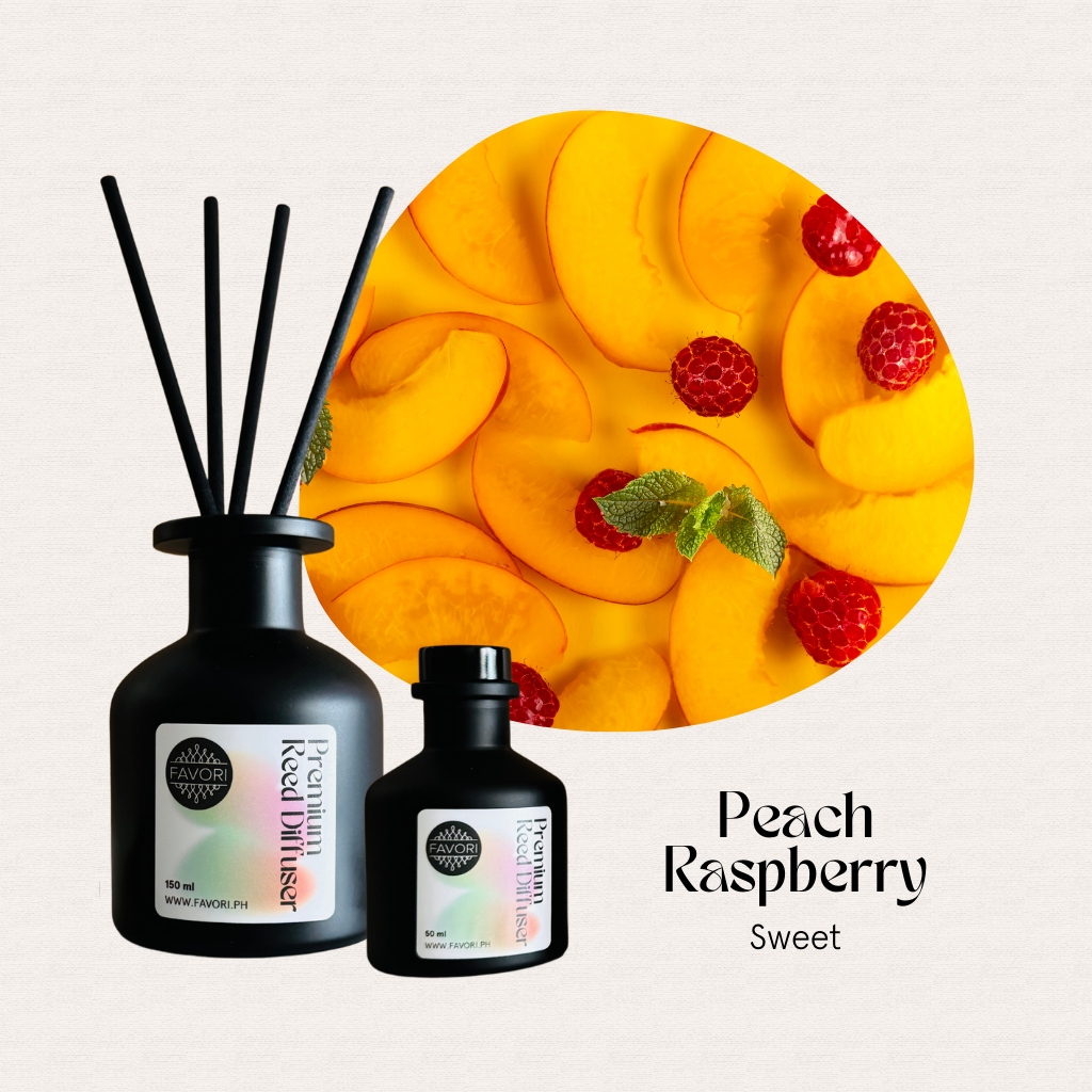 FAVORI Scents Peach Raspberry Premium Reed Diffuser (PRD) with fiber sticks beside sliced peaches and raspberries.