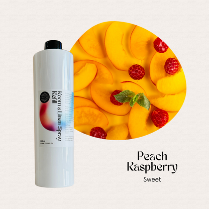 A FAVORI Scents Refill – Regular Room & Linen Air Spray sits beside peach slices, raspberries, and mint.