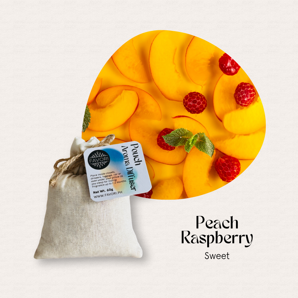 A FAVORI Scents Pouch Aroma Diffuser labeled Peach Raspberry sits below peach slices, raspberries, and aroma oil.