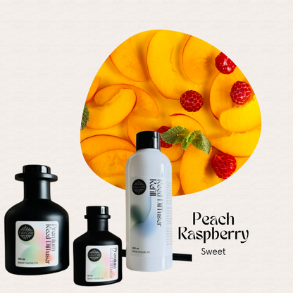 Sliced peaches and raspberries with three FAVORI Scents Peach Raspberry Trio Premium Reed Diffusers and reed sticks.