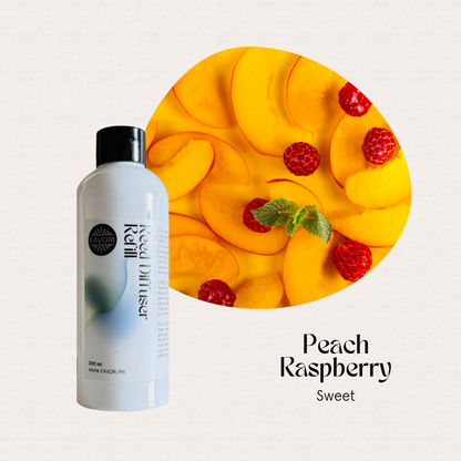 A bottle of FAVORI Scents Peach Raspberry Reed Diffuser Refill next to peaches, raspberries & mint.