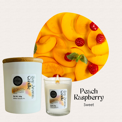 A FAVORI Scents All Occasion soy candle sits beside peach slices and raspberries on a white background.