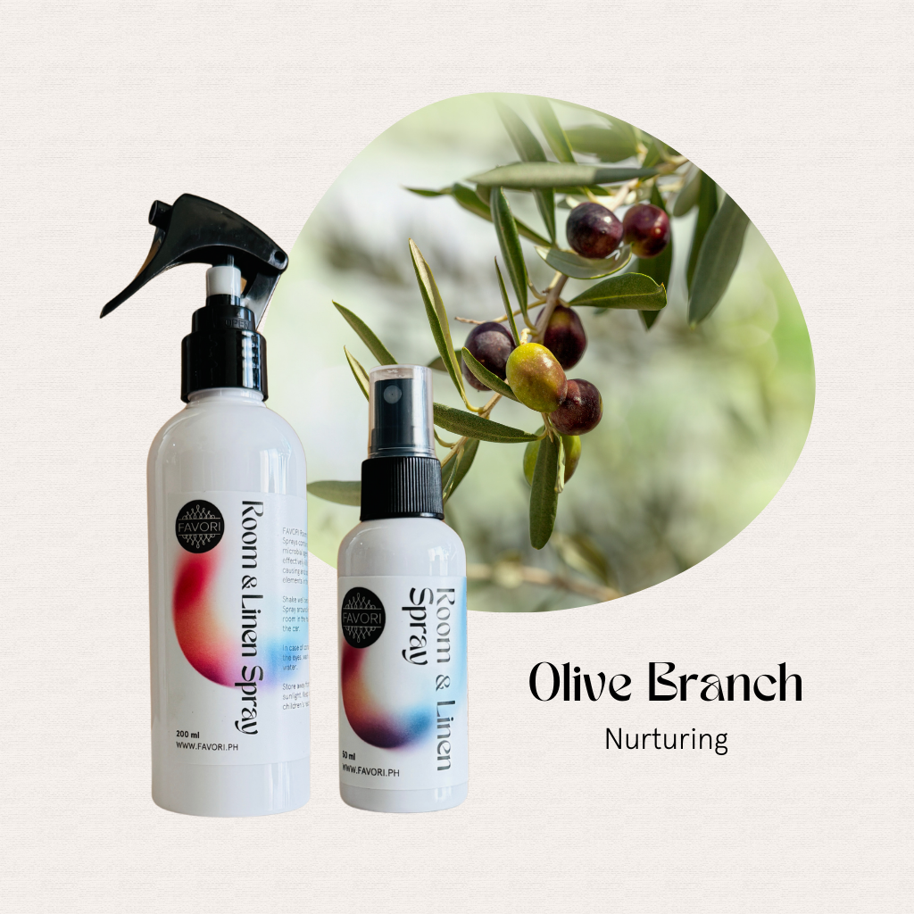Two FAVORI Scents Regular Room & Linen Air Sprays beside olives, labeled Olive Branch Nurturing mood enhancer.