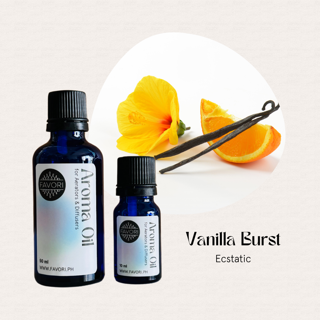 Two blue FAVORI Scents AD Aroma Oils—Vanilla Burst & Ecstatic—beside vanilla, orange, and a flower.