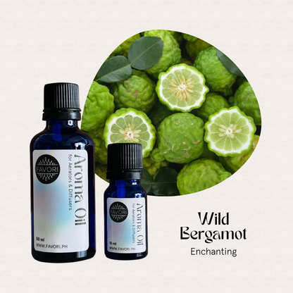 Two FAVORI Scents AD Aroma Oils sit by sliced bergamot, labeled Wild Bergamot: Enchanting.