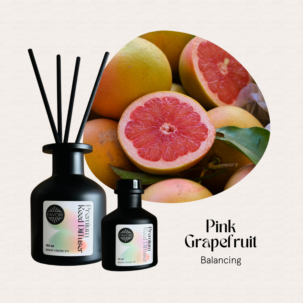 Cut and whole pink grapefruits with FAVORI Scents Pink Grapefruit Premium Reed Diffuser (PRD) for lasting aroma.
