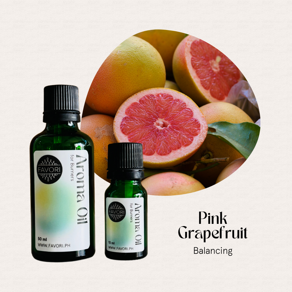 Two bottles of FAVORI Scents Burner Aroma Oils with sliced pink grapefruits. Text: Pink Grapefruit.
