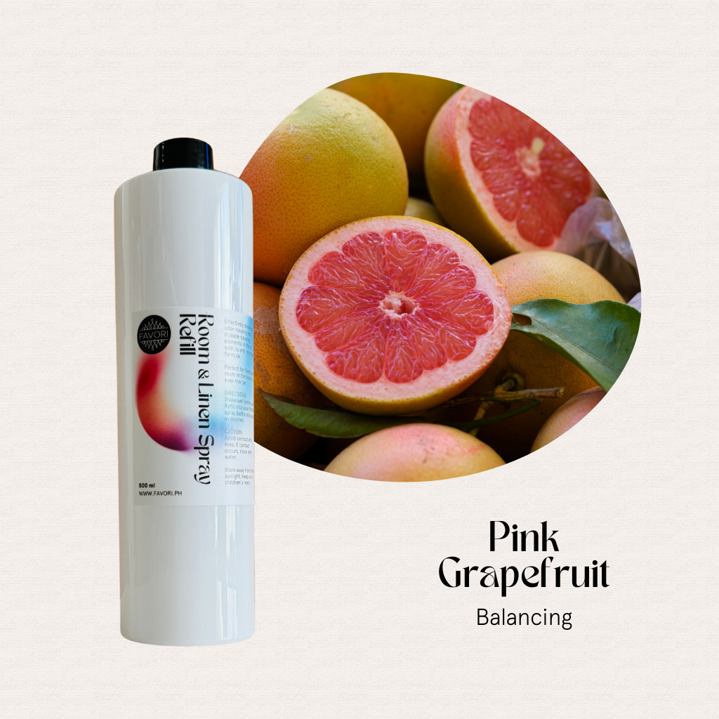 A FAVORI Scents Refill – Regular Room & Linen Air Spray 500ml sits by fruit, ready to eliminate odors.