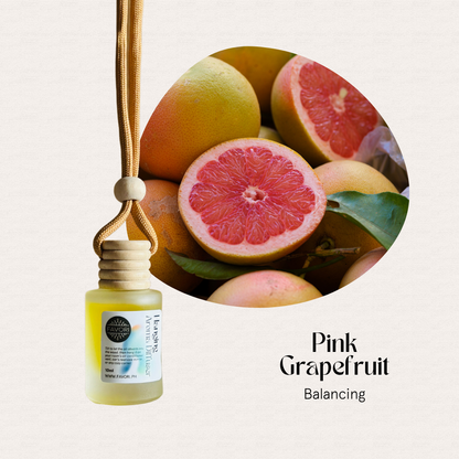 FAVORI Scents Hanging Aroma Diffusers (HAD) with pink grapefruit fragrance beside fresh grapefruit fruits.